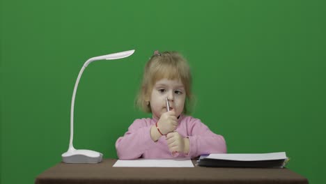 Girl-drawing-at-the-table.-Education-process.-Three-years-old-child.-Chroma-Key