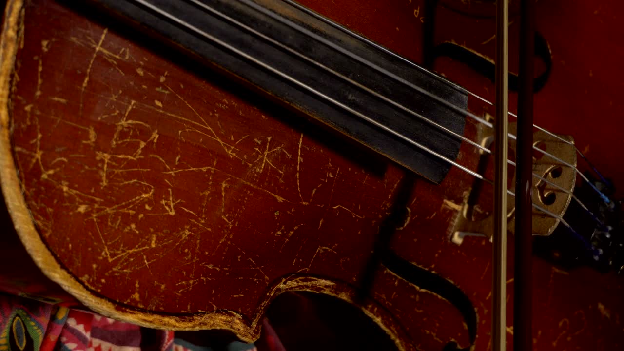 kid playing of old shabby cello