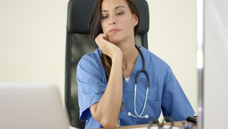 Serious-female-doctor-at-laptop-computer