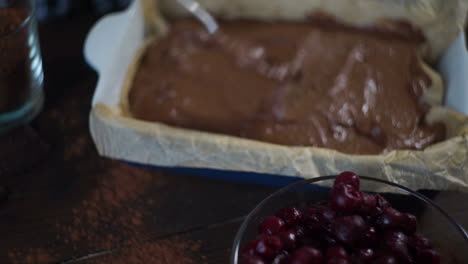 Man-hands-preparing-with-spoon-dough-for-baking-chocolate-pie