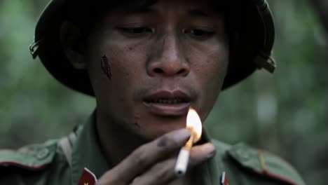 a soldier's moment of reflection: lighting a cigarette in the depths of the jungle captures the struggles and solitude of war