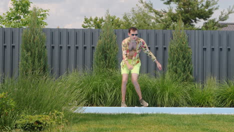 man dancing by a pool