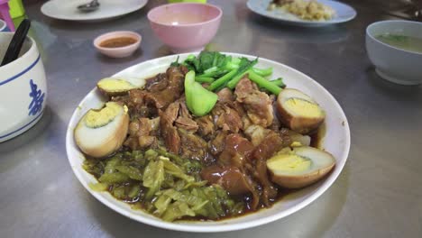 slow-braised pork leg, a beloved delicacy in thailand's vibrant street food culture