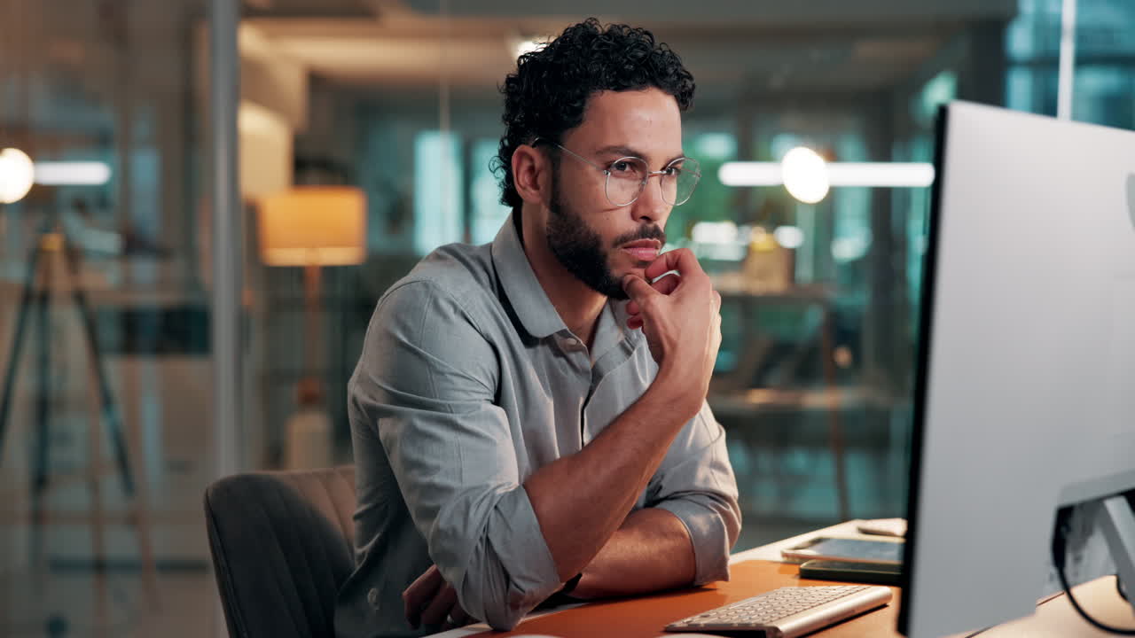 Man Working on Computer in Modern Office at Night