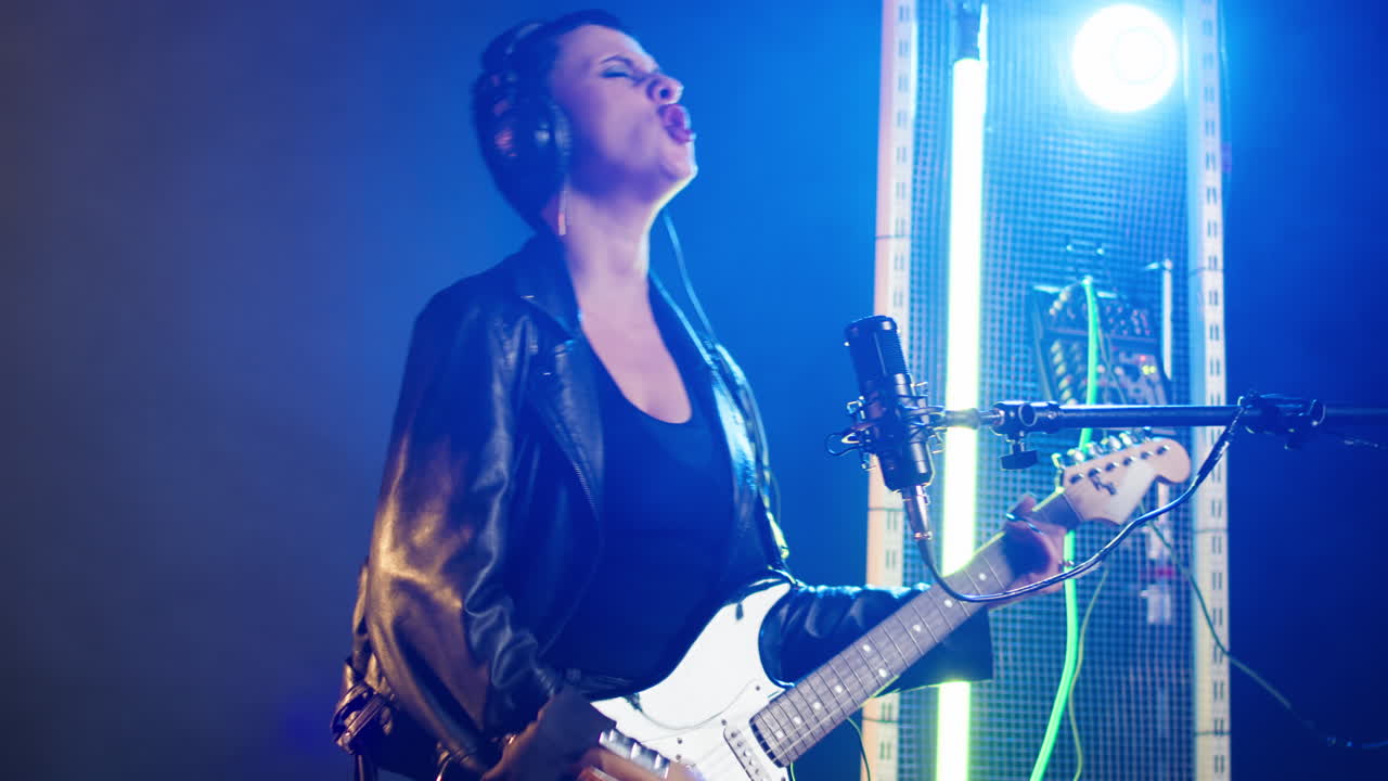 Musician Performing Live with Guitar and Microphone