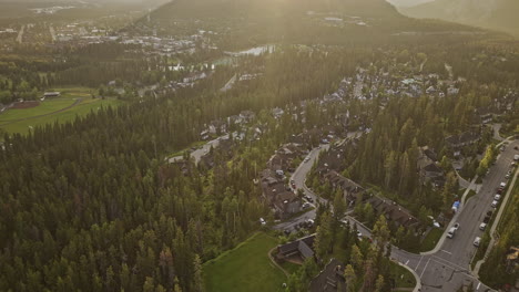 banff ab canada aerial v17 drone flyover residential neighborhood towards the town across bow river capturing local community surrounded by forested valleys - shot with mavic 3 pro cine - july 2023