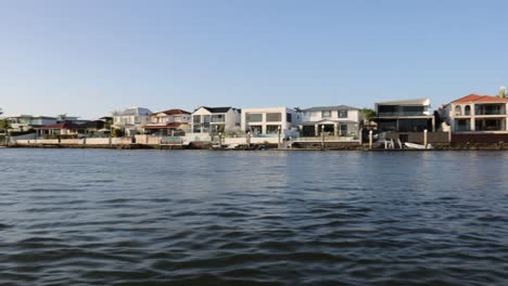 series of waterfront homes viewed from a moving boat