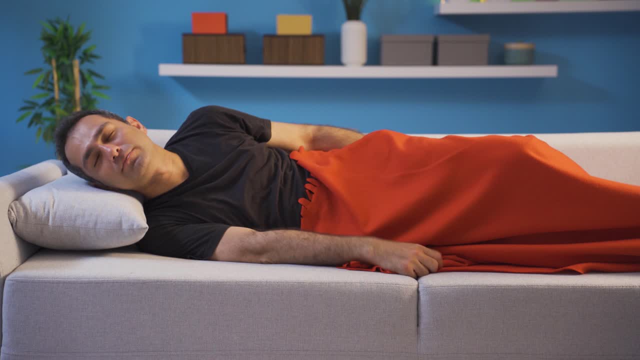 Man unable to sleep in bed thoughtful, has trouble sleeping.