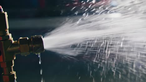 high-pressure water spraying from a hose nozzle: a close-up look at fluid dynamics in action