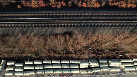 a drone view of a fenced off area by train tracks