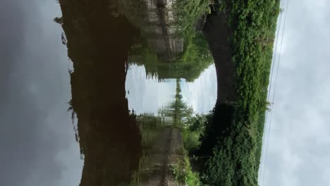 passing under stone bridge pov vertical shot