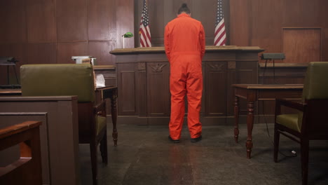 inmate looking sad in the court room in front of judge