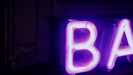 flickering purple neon sign spelling bar shines on a wet night, reflecting the vibrant nightlife of the urban scene