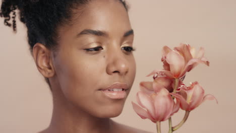 close up beauty portrait attractive african american woman touching body with orchid flower caressing healthy skin complexion enjoying gentle fragrance of natural essence skincare concept