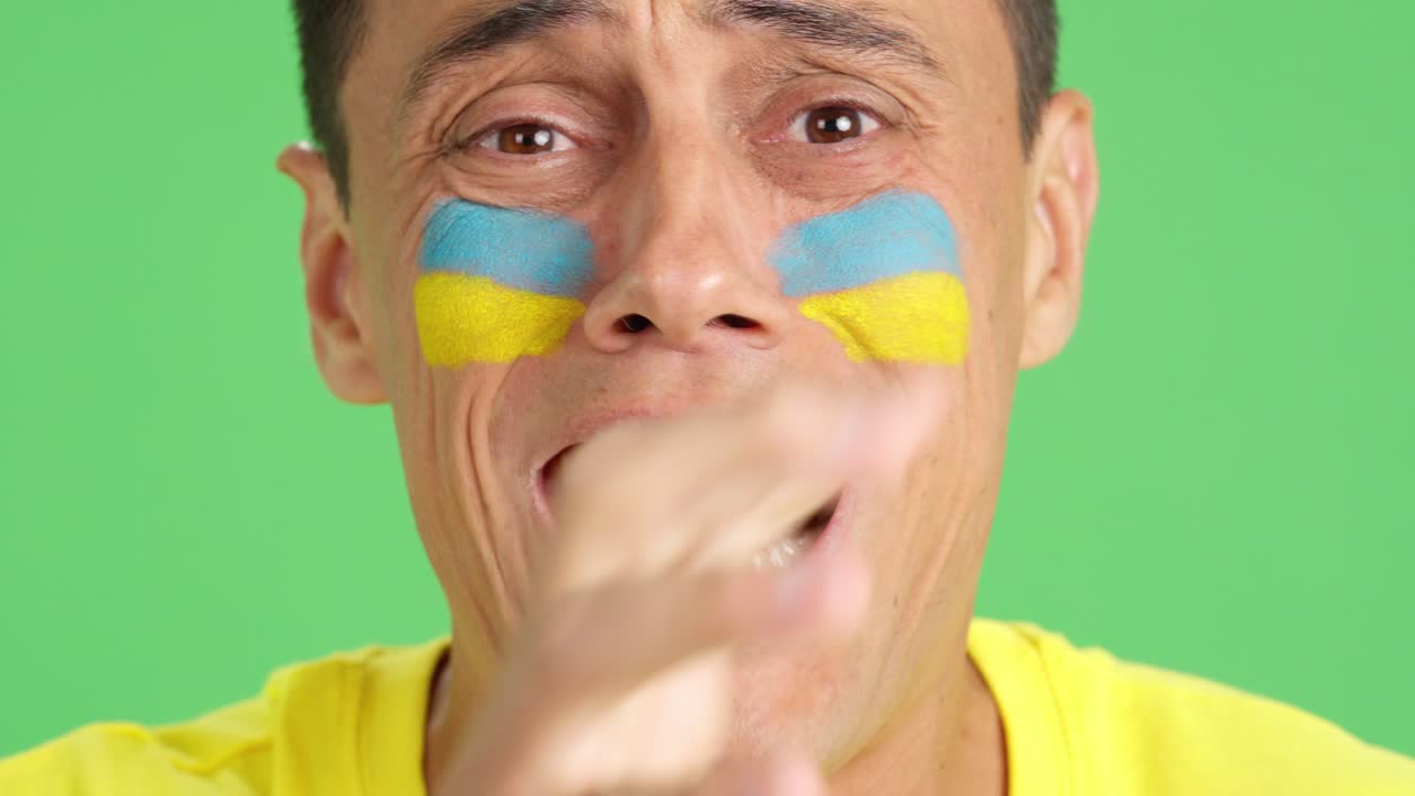 Very nervous man supporting ukrainian team during a difficult match