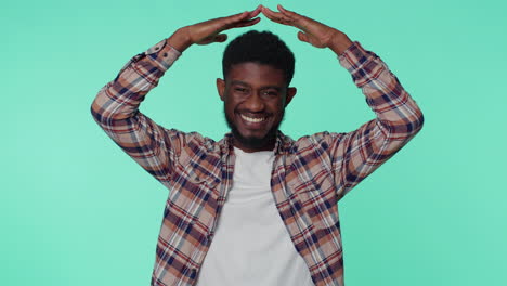 man playing childish catching up game, feeling in safe making roof above head with hands, insurance