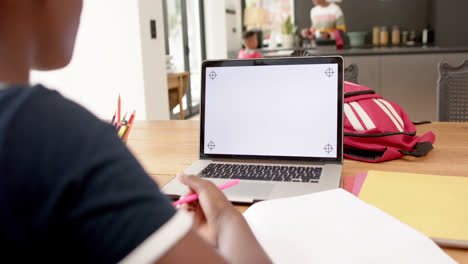 African-american-girl-in-online-class-using-laptop-with-copy-space,-slow-motion