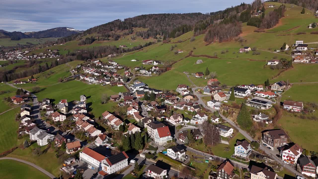 Luchtfoto van een schilderachtig landelijk dorp in een bergachtig Zwitsers landschap