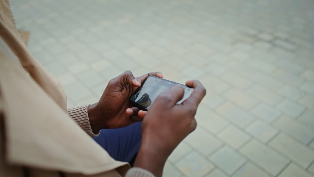 Person playing a mobile game