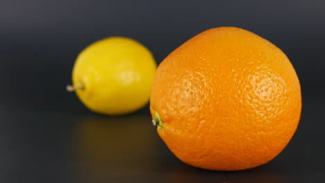 Orange-fruit-focus-vs-lemon-in-background,-citrus,-food,-fresh,-juicy,-vitamin,-vegetables,-macro-studio-shot-illustration,-nutrition,-colorful-dessert,-aliment-fruits