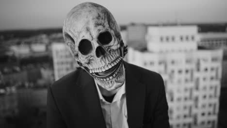 person in a skull mask in an urban setting