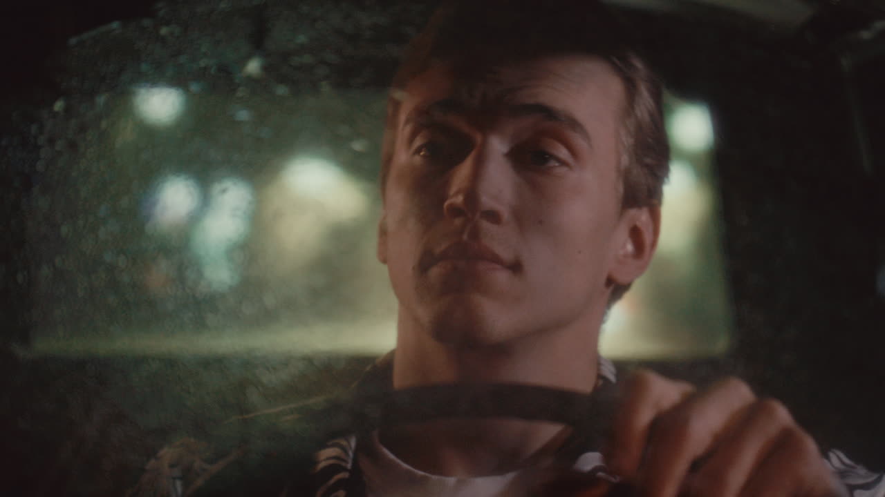 Man Driving Vintage Taxi Cab at Night with Raindrops on Windshield