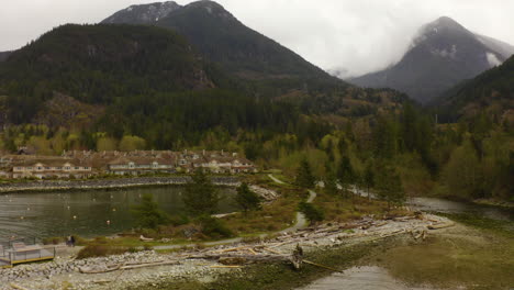 aerial drone view flying toward waterfront homes along the pacific coast in british columbia