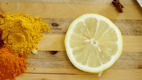 various spices with lemon slice and knife on chopping board 4k