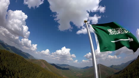 saudi arabia flag flying over mountains