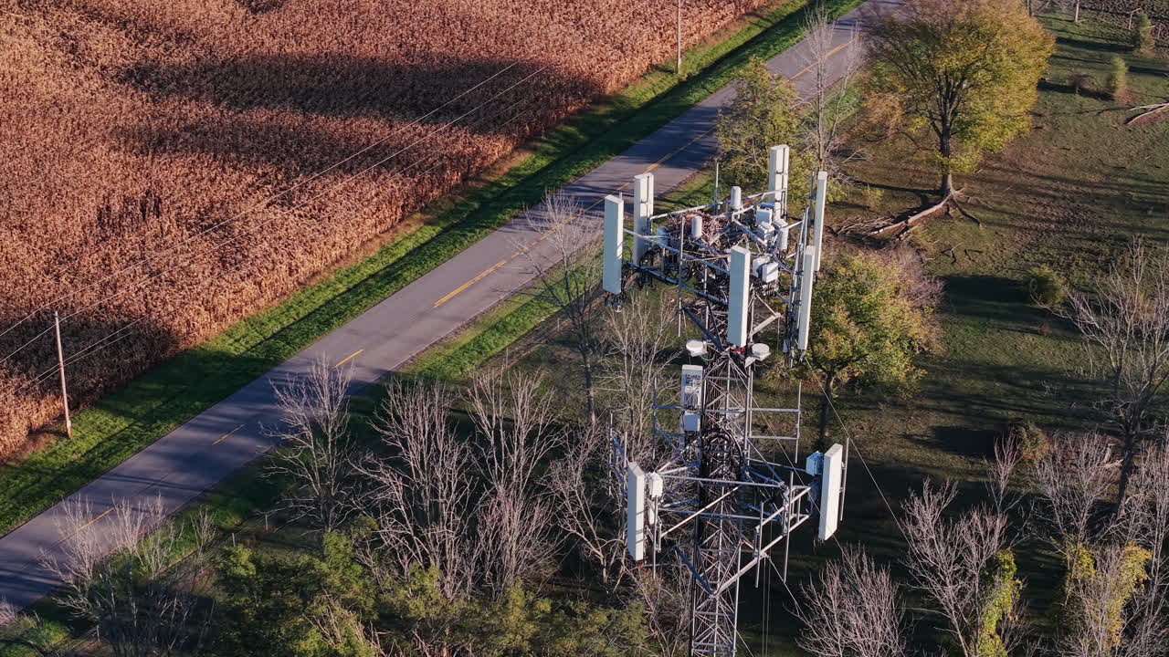 Aerial view of a cell tower near a road and field