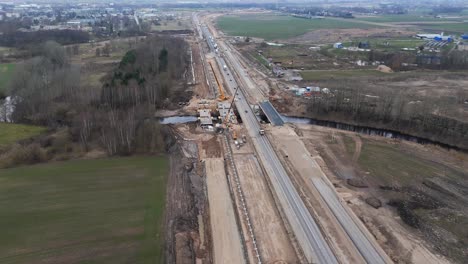 aerial shot of the road under construction for the expansion project, there is a construction site with the equipment for work