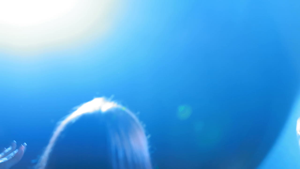 Woman singing on dark stage. Young pretty woman singing in microphone on dark stage