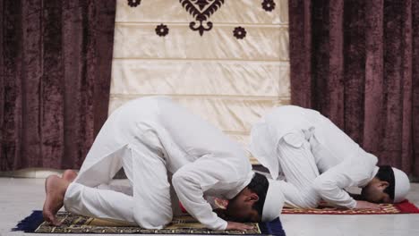 indian muslim men reading namaz and doing prayers