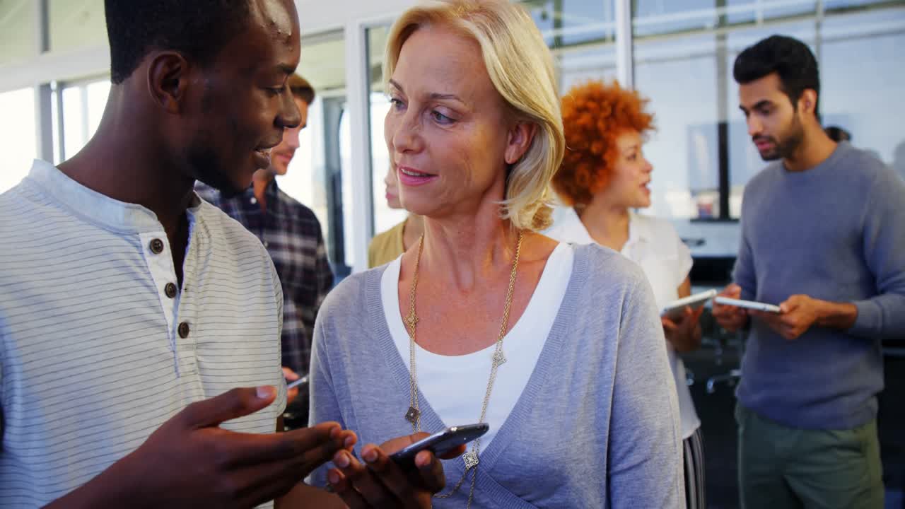 Executives discussing over mobile phone