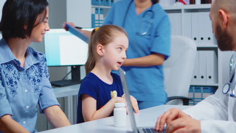 physician talking with child and mother