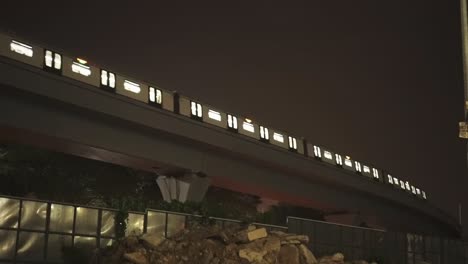 train passing at night in city urban area