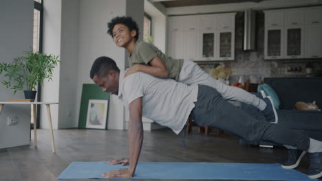 father and son doing push-ups together at home