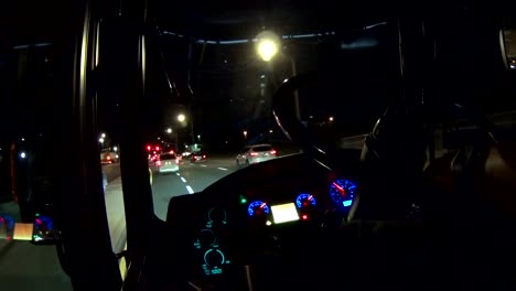 bus driver pov at night driving on a city street