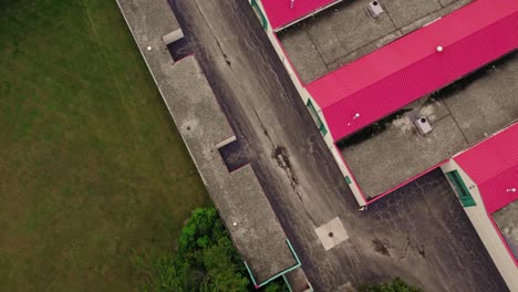 top down aerial revealing rental public storage with red roofing in america