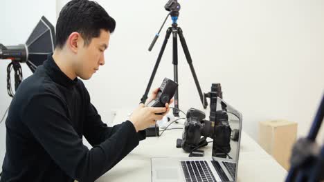 Male-photographer-working-at-desk