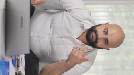 Vertical-video-of-Home-office-worker-man-finds-what-he-is-looking-for-on-the-table.