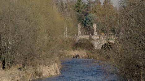 San-Pablo-Bridge-over-the-Arlanzon-River-in-Burgos,-Spain,-wide-shot-slow-motion