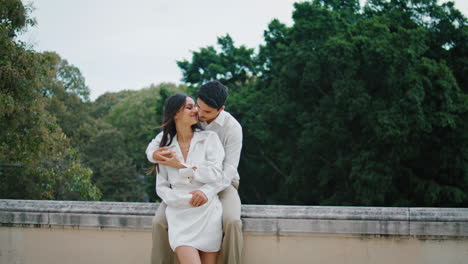 Lovely-pair-embracing-together-on-rooftop-vertical.-Two-hispanic-lovers-date