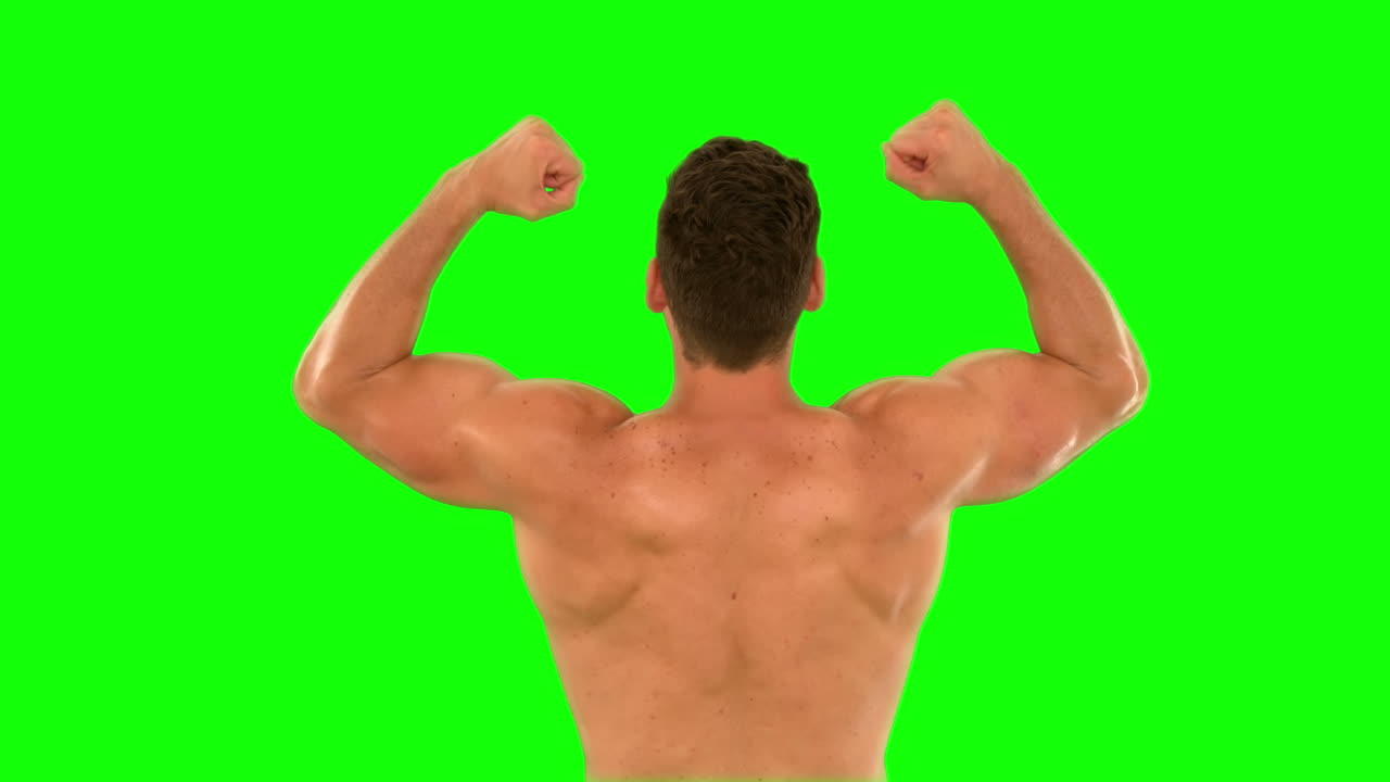 Muscular man cheering and jumping