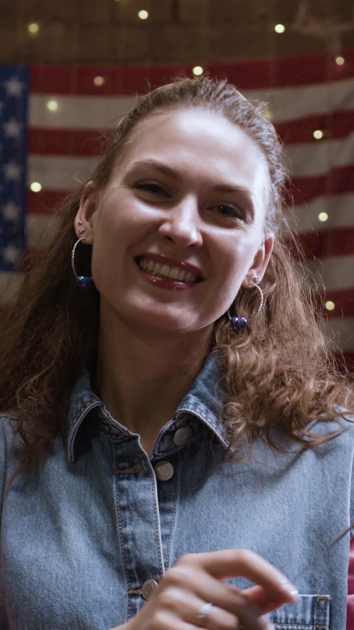 Woman with sparkler in front of American Flag