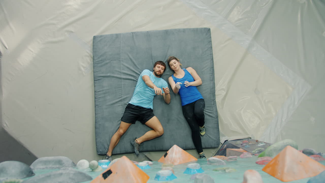 Couple Relaxing on a Bouldering Mat