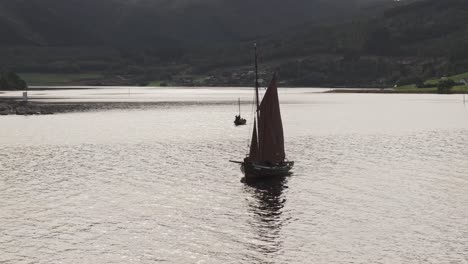 two sailing boats on a calm fjord