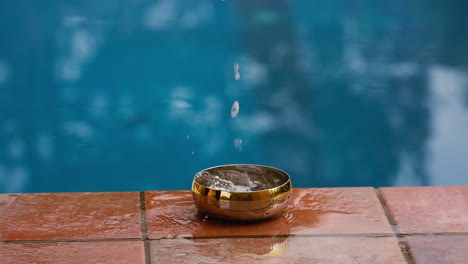 dropping a small piece of metal in a bowel of water causing a big splash