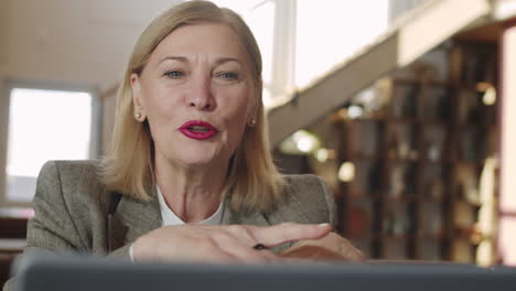 senior businesswoman web calling on laptop in restaurant