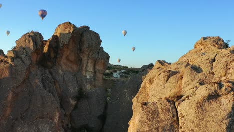 Aerial-view-of-hot-air-balloon-flying-over-Cappadocia-at-summer-sunrise